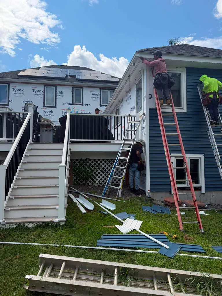 Siding installation crew working on a home exterior