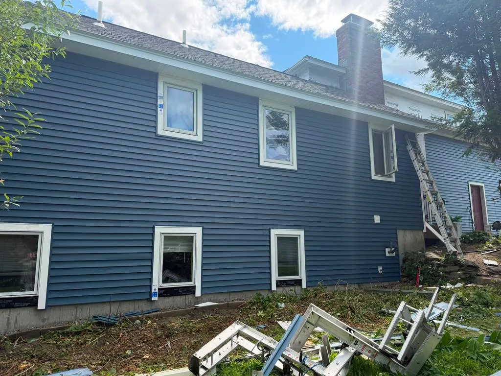Blue vinyl siding installed on a Massachusetts home