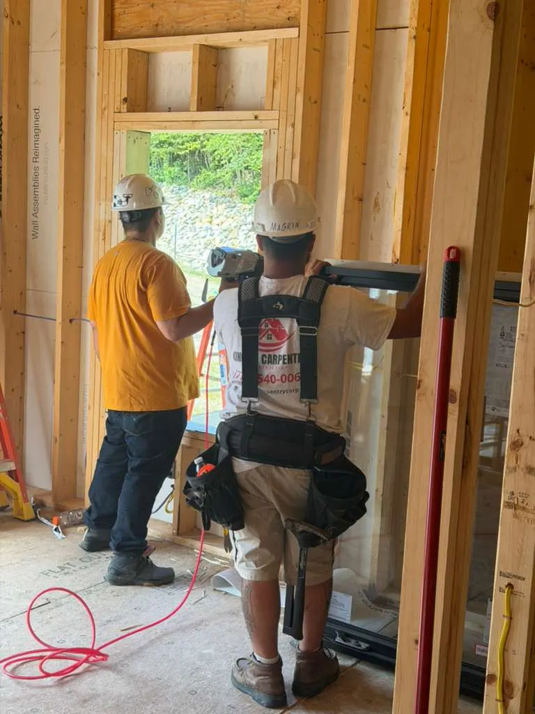 Carpenters framing interior walls of a home in Massachusetts